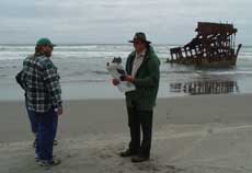 The wrecxk of the Peter Iredale is gradually returning to the sea.